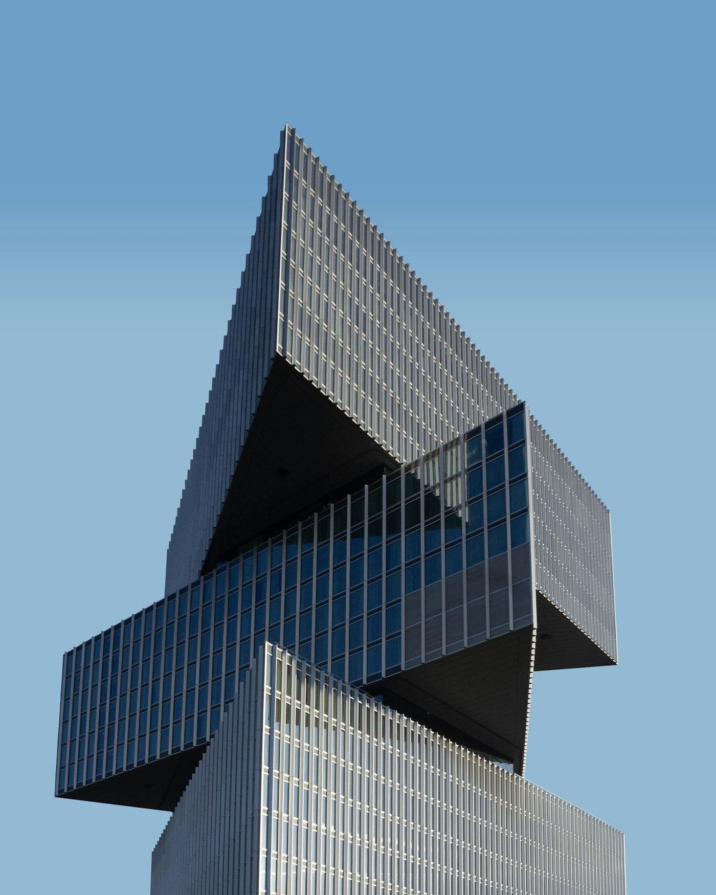 A modern tower facade against a clear sky