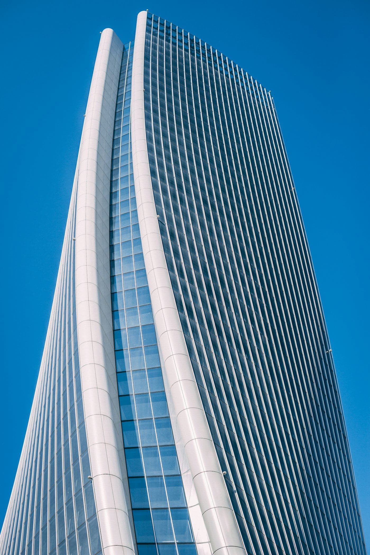 A white tower rising into a blue sky